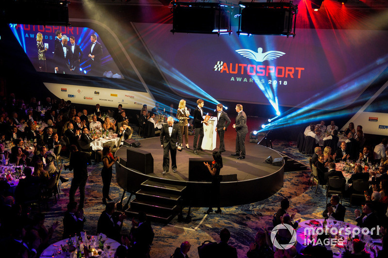 Williams F1 Driver George Russell, and McLaren F1 driver Lando Norris on stage to present the National Racing Driver Award to Dan Ticktum, accepted on his behalf by Derek Warwick