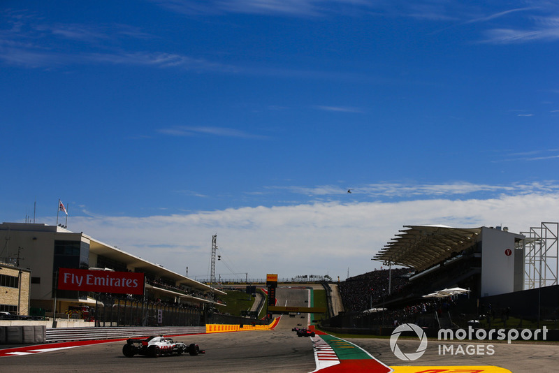 Sebastian Vettel, Ferrari SF71H, leads Kevin Magnussen, Haas F1 Team VF-18