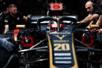 Kevin Magnussen, Haas F1 Team VF-19, is attended to by mechanics