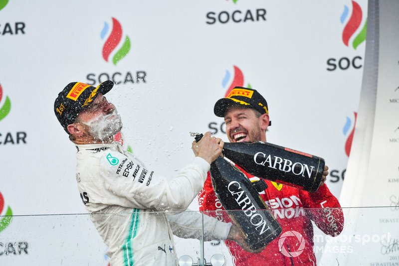 Valtteri Bottas, Mercedes AMG F1, 1st position, blasts himself with Champagne on the podium and Sebastian Vettel, Ferrari, 3rd position, joins in