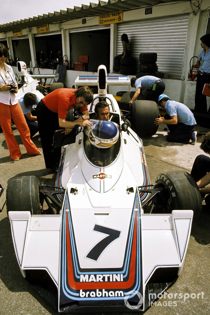 Bernie Ecclestone, F1 Supremo manages a smirk as a deadly serious Carlos Reutemann, Brabham BT44B ponders on his eighth place finish