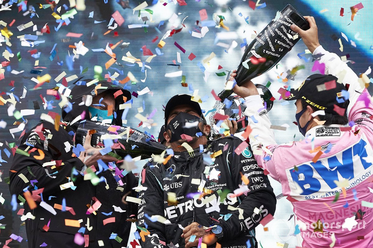 Toto Wolff, Executive Director (Business), Mercedes AMG, Lewis Hamilton, Mercedes-AMG F1, 1st position, and Sergio Perez, Racing Point, 2nd position, celebrate with champagne on the podium