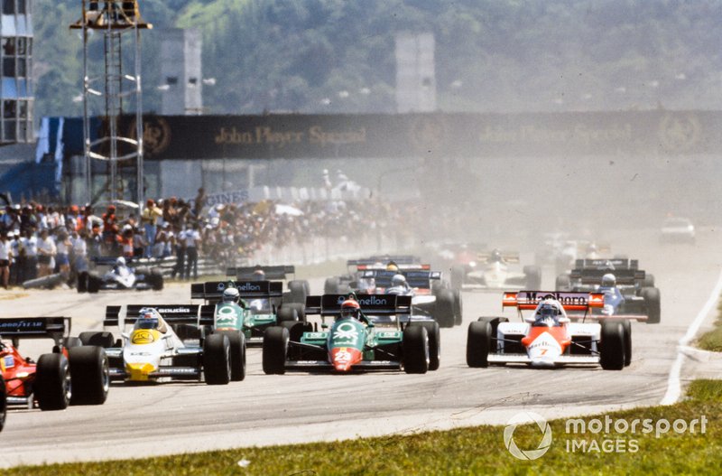 Keke Rosberg, Williams FW09 Honda, battles with Eddie Cheever, Alfa Romeo 184T, and Alain Prost, McLaren MP4-2 TAG, at the start