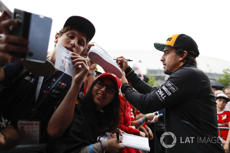 Fernando Alonso, McLaren, signs autographs for fans