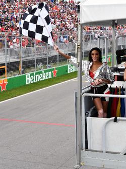 Winnnie Harlow, waves the chequered flag