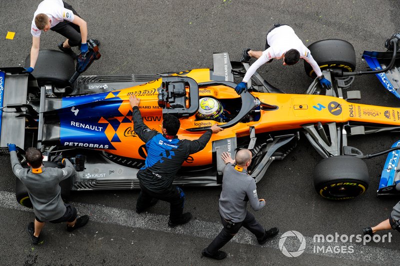 Lando Norris, McLaren MCL34, is returned to the garage