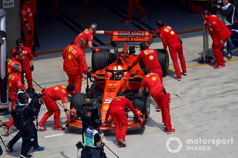 Sebastian Vettel, Ferrari SF90, is returned to the garage