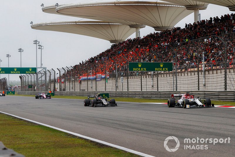 Kimi Raikkonen, Alfa Romeo Racing C38, leads Kevin Magnussen, Haas F1 Team VF-19