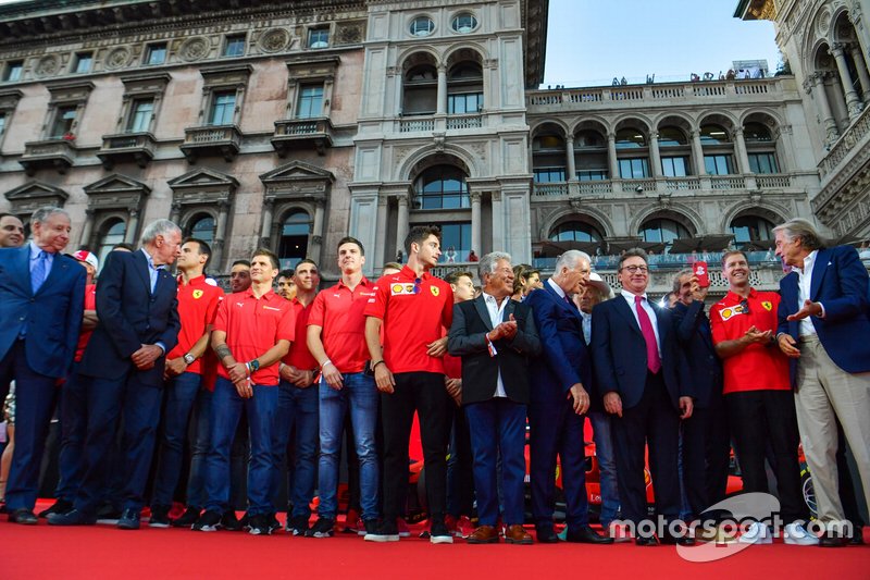 Charles Leclerc, Ferrari, Mario Andretti, and Piero Lardi Ferrari stand amongst the Ferrari Academy drivers and former Ferrari F1 drivers and team personnel