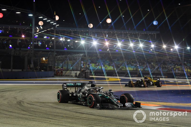 Lewis Hamilton, Mercedes AMG F1 W10 and Kevin Magnussen, Haas F1 Team VF-19