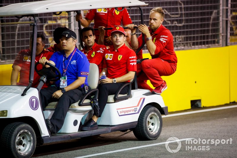 Charles Leclerc, Ferrari walks the track on a gold buggy