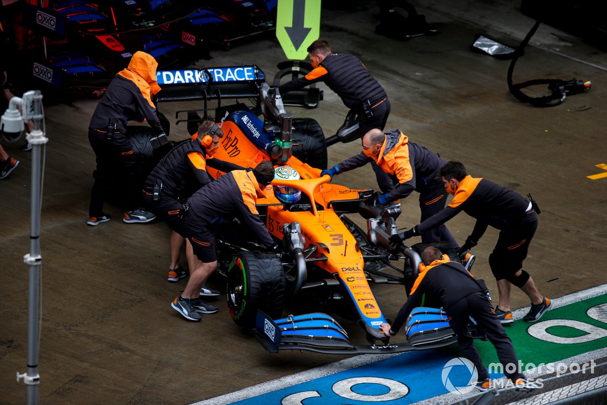 Daniel Ricciardo, McLaren MCL35M, is returned to the garage