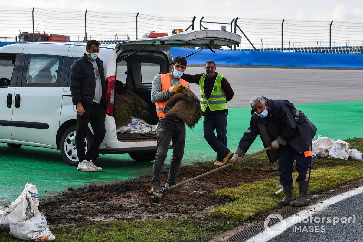 Circuit personnel work on the track