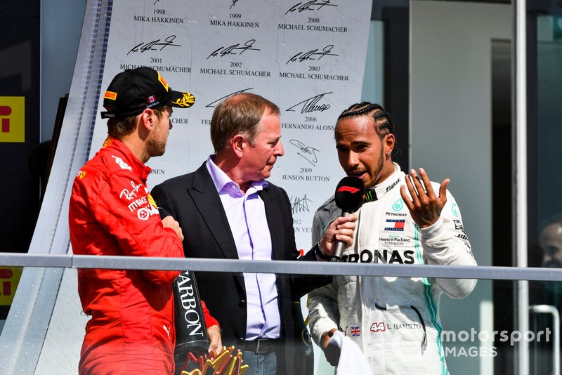 Sebastian Vettel, Ferrari and Lewis Hamilton, Mercedes AMG F1 talk to Martin Brundle, Sky TV on the podium 