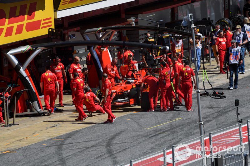 Sebastian Vettel, Ferrari SF90, is returned to the garage