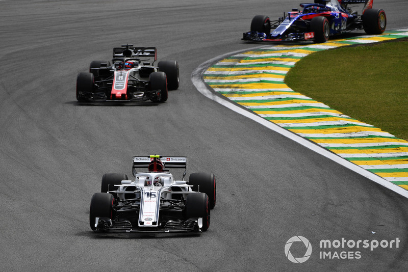 Charles Leclerc, Sauber C37 leads Romain Grosjean, Haas F1 Team VF-18