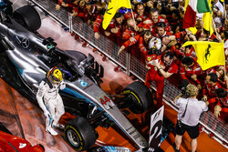 Race winner Sebastian Vettel, Ferrari, celebrates with his team in Parc Ferme as second place Lewis Hamilton, Mercedes AMG F1, gets out of his car