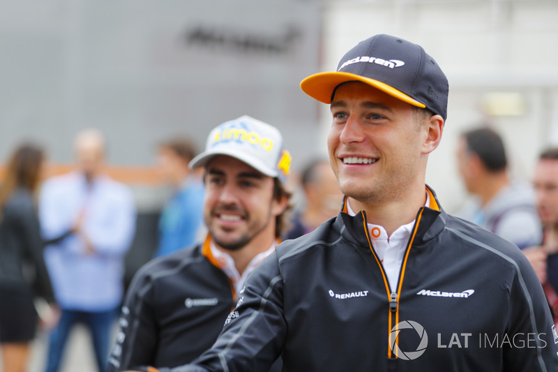 Stoffel Vandoorne, McLaren, and Fernando Alonso, McLaren, play darts