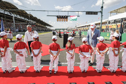 Grid kids shacking hands with Chase Carey, Chairman, Formula One and Sean Bratches, Managing Director of Commercial Operations, Formula One Group