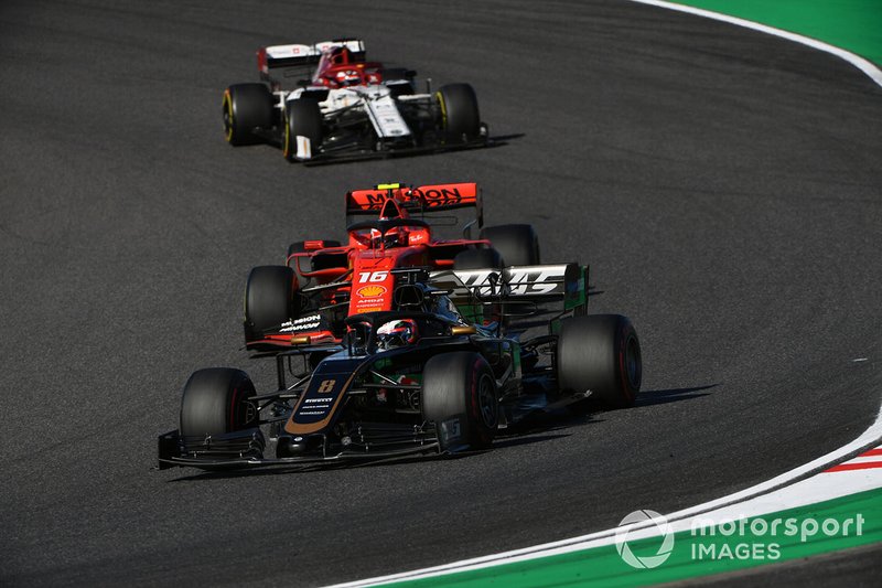 Romain Grosjean, Haas F1 Team VF-19, leads Charles Leclerc, Ferrari SF90, and Kimi Raikkonen, Alfa Romeo Racing C38