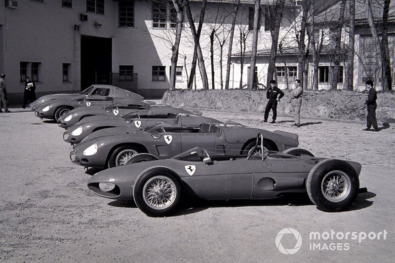 A selection of racing Ferraris are displayed outside the Ferrari factory, including a Ferrari 156 