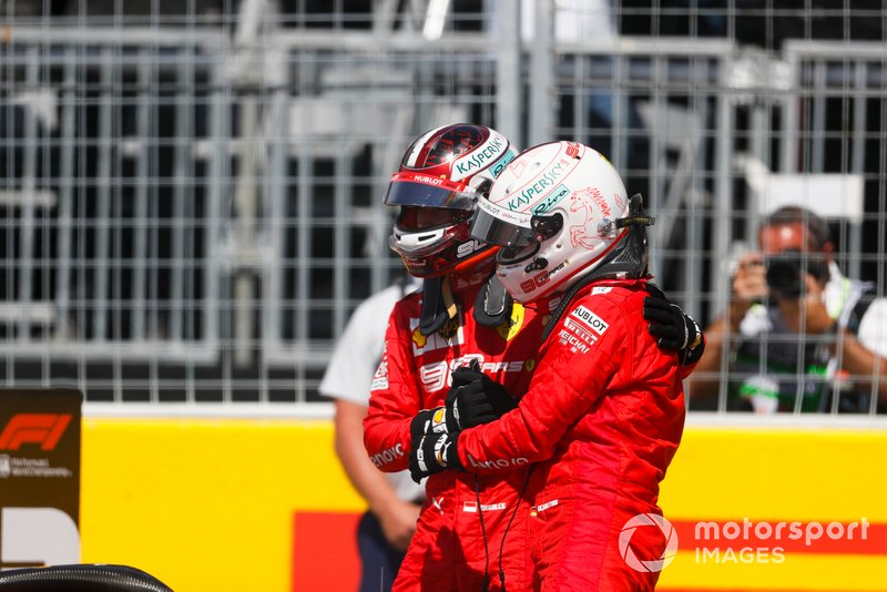 Charles Leclerc, Ferrari, congratulates his team mate, Sebastian Vettel, Ferrari, on pole position