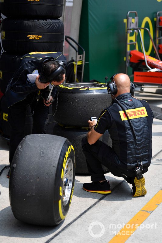 Pirelli technicians examine some tyres