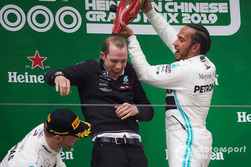 Lewis Hamilton, Mercedes AMG F1, 1st position, pours Champagne down the back of his team mate on the podium