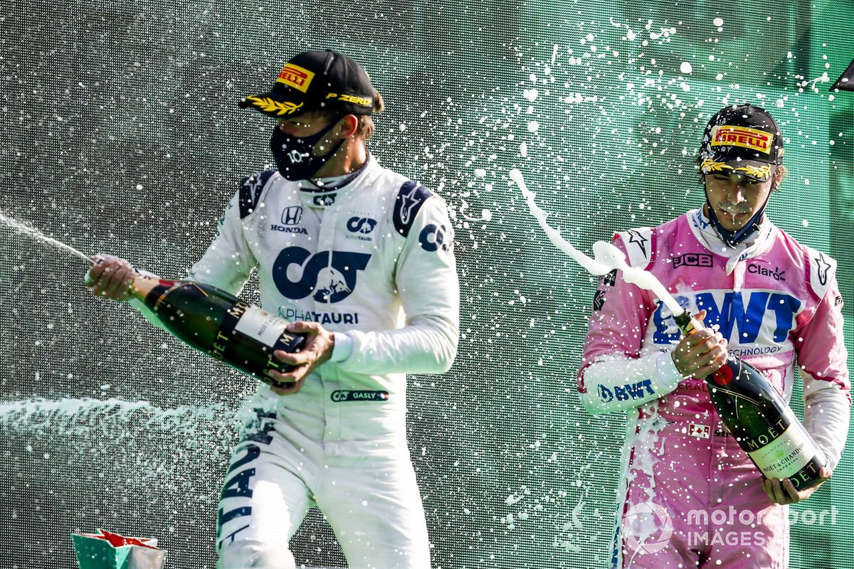 Pierre Gasly, AlphaTauri, 1st position, and Lance Stroll, Racing Point, 3rd position, celebrate on the podium with Champagne