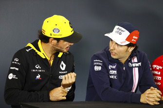 Carlos Sainz Jr., Renault Sport F1 Team, talks to Sergio Perez, Force India, in the Thursday press conference.