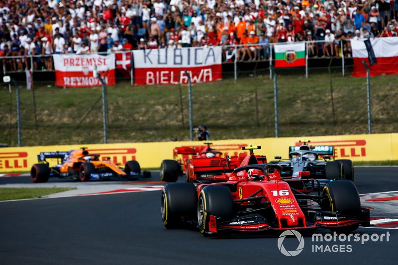 Charles Leclerc, Ferrari SF90, leads Valtteri Bottas, Mercedes AMG W10, Sebastian Vettel, Ferrari SF90, and Carlos Sainz Jr., McLaren MCL34