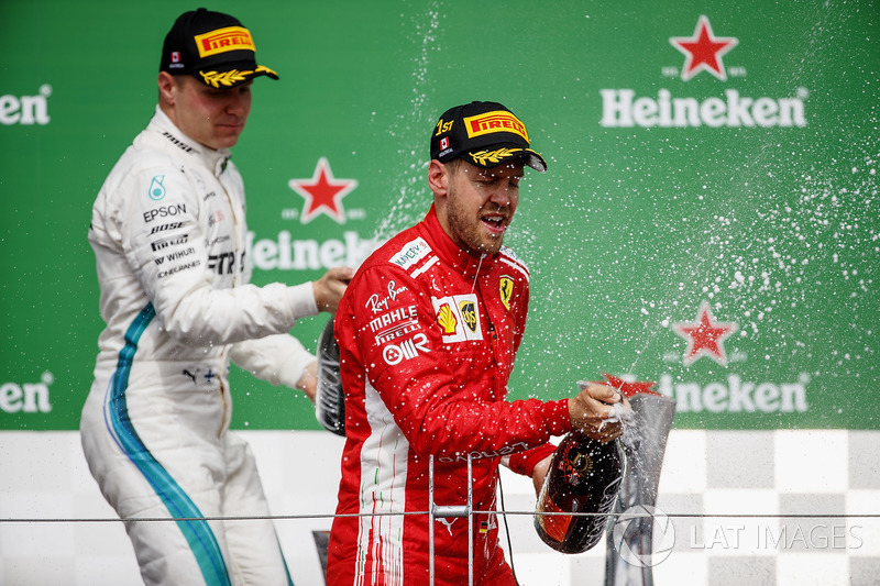Valtteri Bottas, Mercedes AMG F1, 2nd position, and Sebastian Vettel, Ferrari, 1st position, celebra