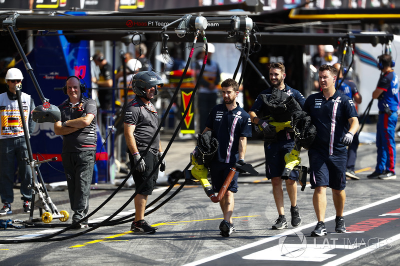 Force India engineers in the pit lane