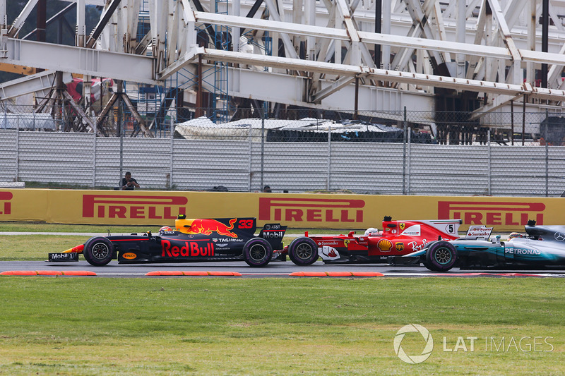 Max Verstappen, Red Bull Racing RB13, Sebastian Vettel, Ferrari SF70H, battle hard at the start of the race as Lewis Hamilton, Mercedes AMG F1 W08, looks to try and take advantage