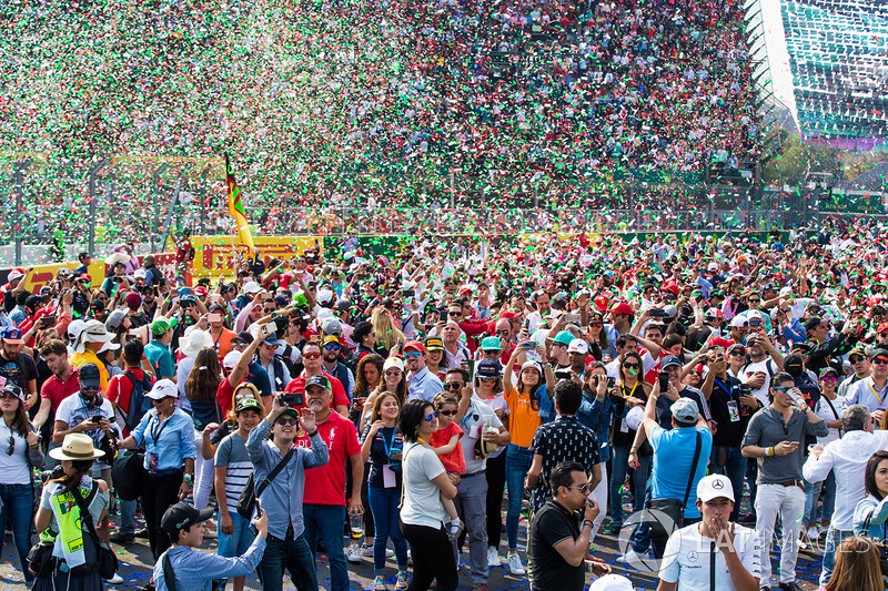 Confetti falls from the podium on to the huge crowd below