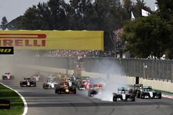 Lewis Hamilton, Mercedes AMG F1 W07 Hybrid locks a wheel under braking into turn one ahead of Max Ve