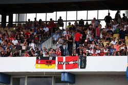 Sebastian Vettel, Ferrari and Kevin Magnussen, Renault Sport F1 Team fans in the grandstand