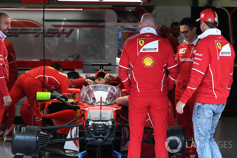Sebastian Vettel, Ferrari looks at Ferrari SF70H with cockpit shield
