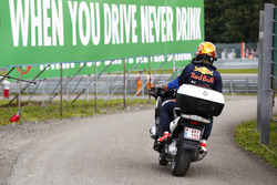 Max Verstappen, Red Bull Racing on a motorcycle after retiring