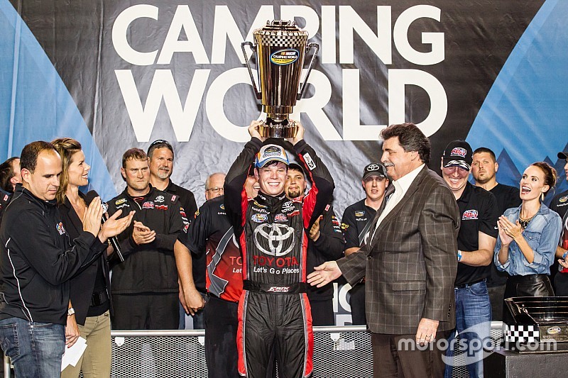 Championship victory lane: NASCAR Camping World Truck Series 2015 champion Erik Jones, Kyle Busch Motorsports celebrates with NASCAR President Mike Helton