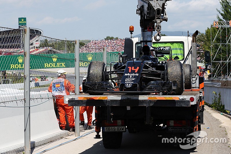 The McLaren MP4-31 of race retiree Fernando Alonso, McLaren is recovered back to the pits on the back of a truck