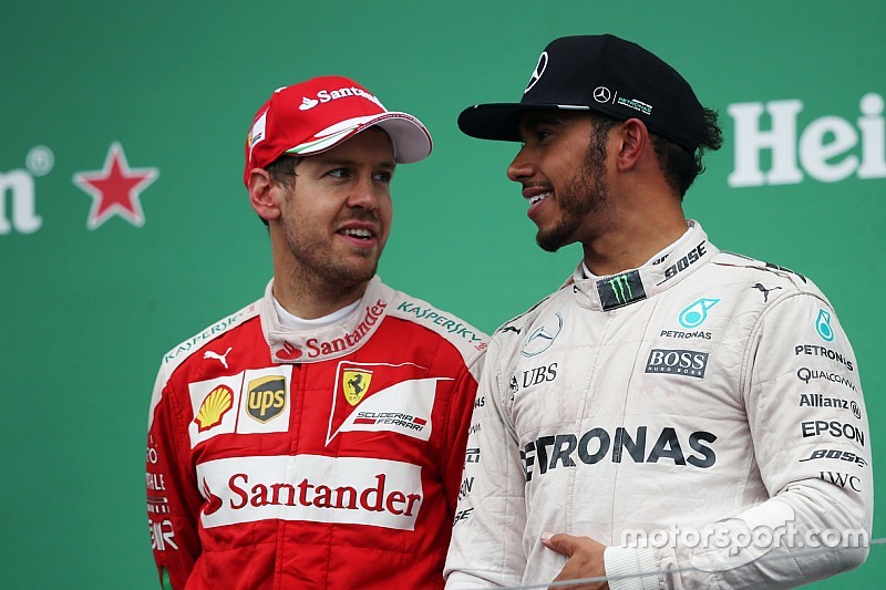 (L to R): Sebastian Vettel, Ferrari with race winner Lewis Hamilton, Mercedes AMG F1 on the podium