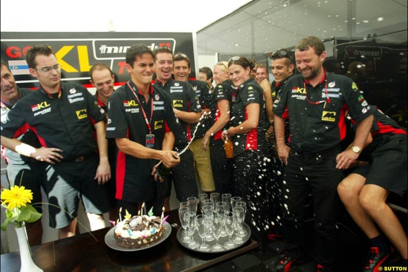 The Minardi team celebrates Alex Yoong's 26th birthday. Saturday, French Grand Prix, Magny Cours, France, July 20th 2002.