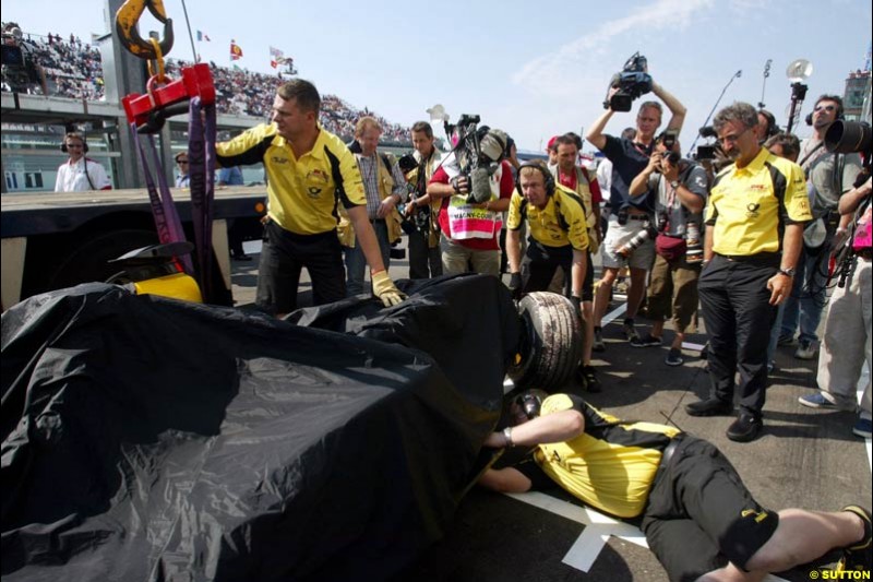 Jordan crew inspect Giancarlo Fisichella's car after the crash. Saturday Free Practice, French Grand Prix, Magny Cours, France, July 20th 2002.