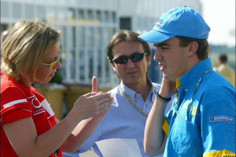 Michael Schumacher's press officer Sabine Kehm talks to Renault's Fernando Alonso. Saturday Free Practice, French Grand Prix, Magny Cours, France, July 20th 2002.