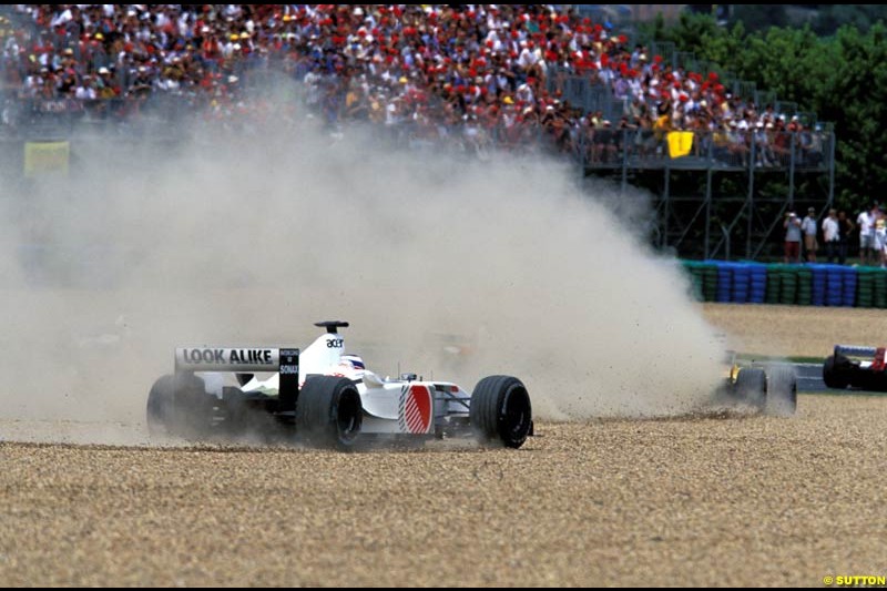 Olivier Panis, British American Racing and Takuma Sato, Jordan, take a trip across the gravel after a first corner collision. French Grand Prix, Magny Cours, France, July 21st 2002.