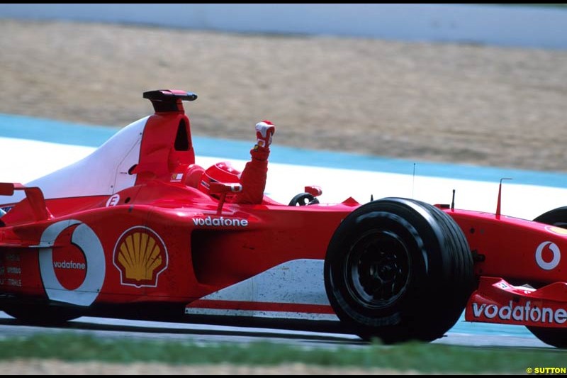 Michael Schumacher celebrates victory. French Grand Prix, Magny Cours, France, July 21st 2002.