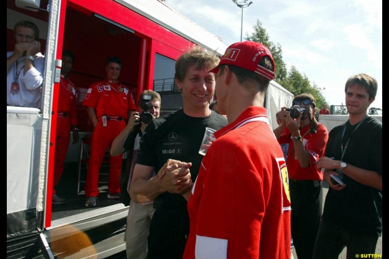 Mario Ilien of Ilmor Engines congratulates Michael Schumacher. French Grand Prix, Magny Cours, France, July 21st 2002.