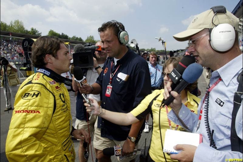 Giancarlo Fisichella, Jordan, talks to a TV crew. German Grand Prix, Hockenheim, Germany, July 27th 2002.