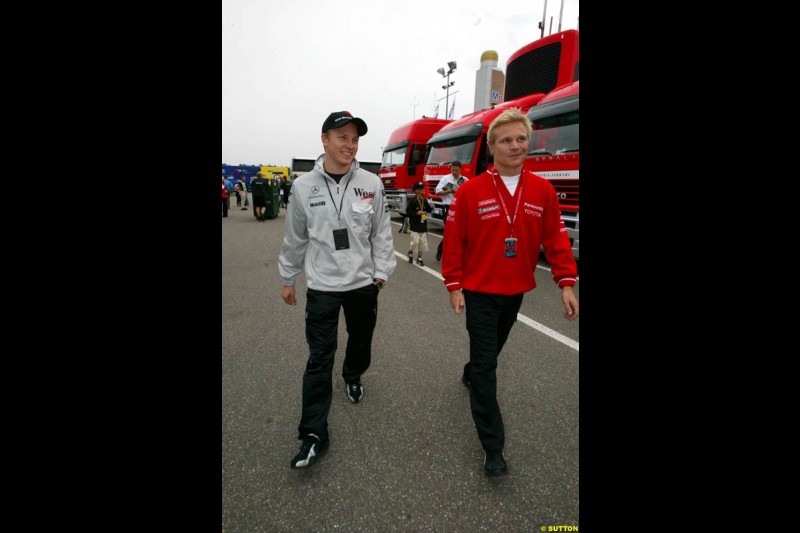 Kimi Raikkonen, McLaren, walks with Mika Salo, Toyota. German Grand Prix, Hockenheim, Germany, July 27th 2002.